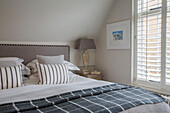 Dark grey blanket on double bed in West Sussex home