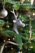 Reindeer head bauble and streamers in Christmas tree Liverpool