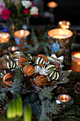 Scented orange peel with pine needles and lit tealights in Liverpool home