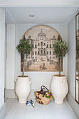 Houseplants ad historic urban scenic with bag and shoes in entrance hall of converted South London schoolhouse UK
