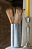 Long matchsticks with silver candlestick in Gloucestershire barn conversion UK
