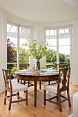 Antique dining table and chair in window of Grade II listed villa Arundel West Sussex UK