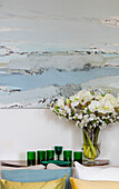 Cut flowers with green glassware and seascape in Grade II listed villa Arundel West Sussex UK