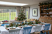 Blue and white dining table with Christmas tree in 1930s Arts and Crafts home West Sussex UK