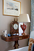 Vintage lamp and clock on table in Wiltshire home England UK