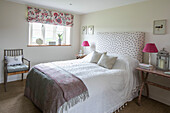 Floral blinds and embroidered blanket in double bedroom of Somerset farmhouse UK