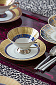 Oriental cups and saucers with spoons on tray in Victorian terrace London UK