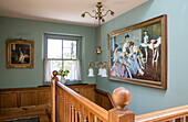 Large artwork of ballerinas in staircase with wooden banister Devon home UK