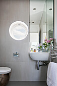 Porthole window and corner mirror in renovated North London Victorian terrace UK