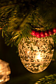 Vintage bauble with cranberry garland in Hampshire cottage at Christmas