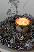 Lit candle and pinecones on East Dulwich home London UK