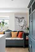 dark grey seating and storage with large canvas of a sheep in Hampshire home UK
