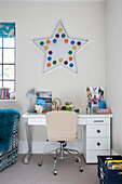 Star light above desk with chair in modernised Arts and Crafts style London home UK