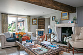 Light grey beamed living room with doors to garden in Oxfordshire home UK