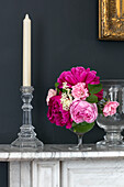 Summer flowers in glass vase with candle in Kent cottage UK