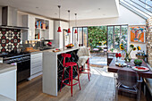 Open plan kitchen extension with view to garden in London family home UK