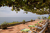 Sunloungers on shaded terrace of Italian villa on the Amalfi coast