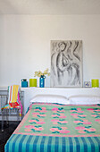 Art sketch on shelf above bed with pink and turquoise cover in Italian villa on the Amalfi coast