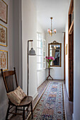 Vintage wooden chair and carpet runner in hallway of Issigeac townhouse Perigord France