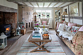 Stone fireplace c1600?s with French coffee table and sofa in Surrey farmhouse UK