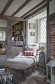 Bolster on French chaise at leaded window in Surrey farmhouse UK