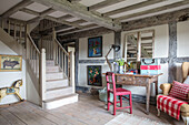 Desk and chair in timber framed entrance of Surrey farmhouse UK