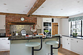 Barstools in modernised kitchen of Kent farmhouse UK