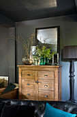 Cut flowers on Oakland 10-drawer chest with lamp in Welsh barn conversion UK