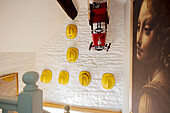 Fire helmets and car on wall in 1840s Cotswolds cottage Oxfordshire UK