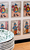 Vintage playing cards and plates in old fire station Cotswolds Oxfordshire UK