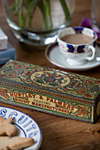 Vintage tin with biscuits and tea inGeorgian rectory West Sussex UK