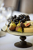 Figs cheese and grapes on marble stand in Surrey cottage UK