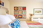 Colourful artwork and pillows in child's room in Grade II listed farmhouse Bodmin Cornwall UK