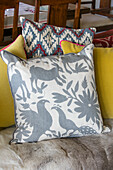 Assorted cushions on sofa in Victorian cottage Midhurst West Sussex UK