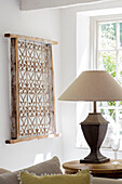 Antique wrought iron window grille and lamp in Surrey cottage UK