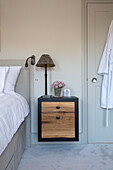 Bespoke bedside cabinet with lamp and roses in London UK