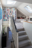 Open plan hidden loft space and snug with trompe l'oeil bookcase London UK