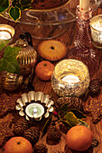 Pine cones and baubles with lit candles in Hampshire UK