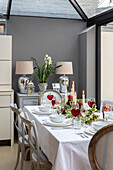 Lit candles and hearts on dining table in extended London villa UK