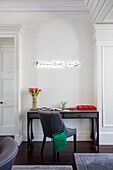 'remember me' light sculpture above desk with chair in London townhouse UK