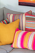 Brightly striped cushions on sofa Surrey UK
