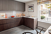 Dark elm veneer kitchen with grey grained pine floor London UK