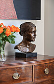 Bronze bust and roses on Georgian chest in Southwest London home UK
