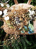 Dried flowers on wooden chair in ferns Isle of Wight hillside UK