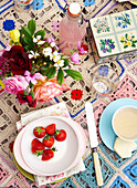 Strawberries and pink lemonade with cut flowers on crochet tablecloth in Isle of Wight home UK