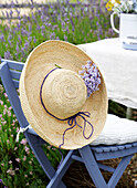 Straw hat on blue folding chair in garden of Isle of Wight home UK