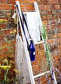 Scented lavender with washbag and soap on ladder in walled garden of Isle of Wight home UK