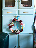 Floral wreath on blue kitchen cabinet Isle of Wight home UK