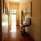 Wood panelled hallway with open door to garden