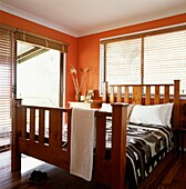 Orange painted bedroom with sliding patio doors and a double bed